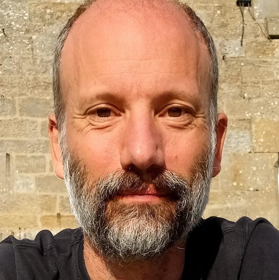 A picture of a middle aged white man with a greying beard